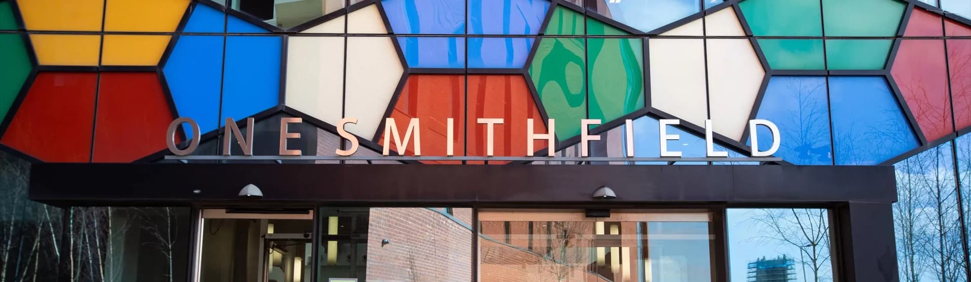 Image of One Smithfield sign above building door